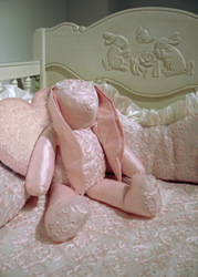 Anastasie bunny & heart-shaped pillow shown resting inside a #200 crib
